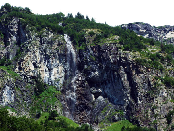 istock Waterfall Sidensackfall or Wasserfall Sidensackfall, Spritzbach stream in the Alpine Valley of Maderanertal 1136513474
