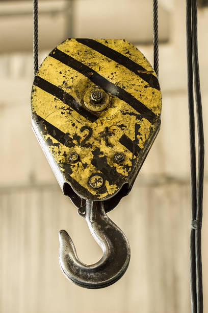 istock Powerful hook crane closeup. Industrial yellow crane hook 1136517206