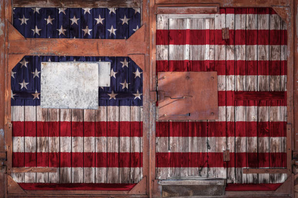istock Close-up of old warehouse gate with national flag 1136518319