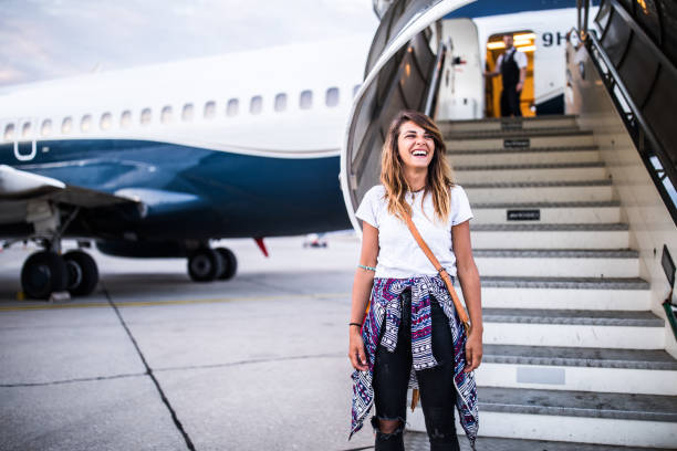 istock Young happy woman disembarking the plane. 1136518843