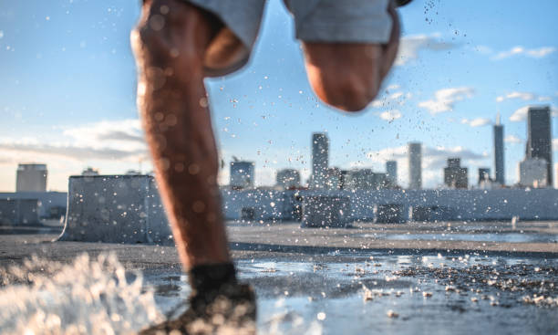 istock Low section of sporty man jogging on rooftop 1136521125