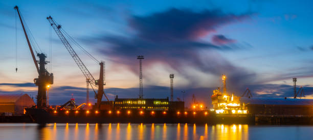 istock bulk cargo ships in the sea port at night, high resolution panorama 1136522841