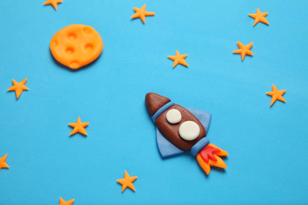 istock Creative craft plasticine rocket in open space, astronaut dreams. Stars, and moon. Cartoon art 1136524477