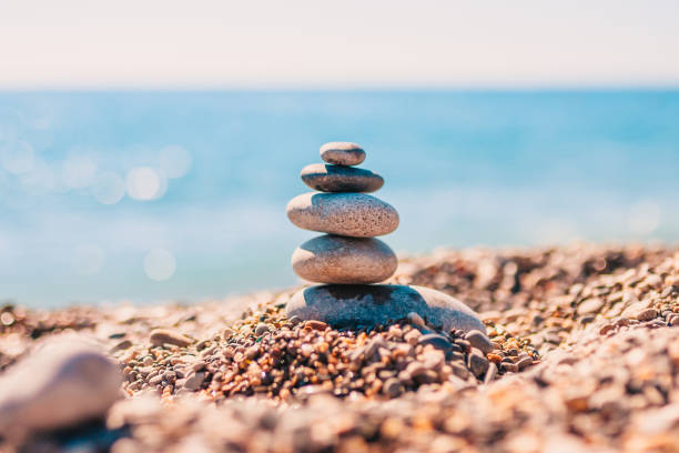 istock Stone pyramid on pebbles on beach - zen rock - balance and harmony 1136524787