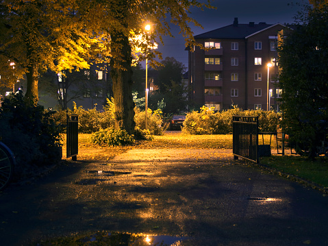 Suburban area during night-time. Dark setting with some lights.