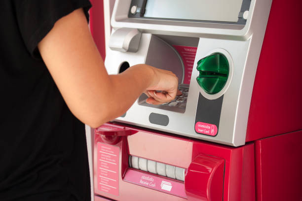 istock Midsection Of Woman Using Atm 1136530144