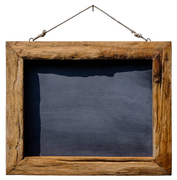 istock An old natural weathered teak wooden framed blackboard hangs from an old rusty nail by old rope against a white background. Isolated on white, clipping path included. 1136531152