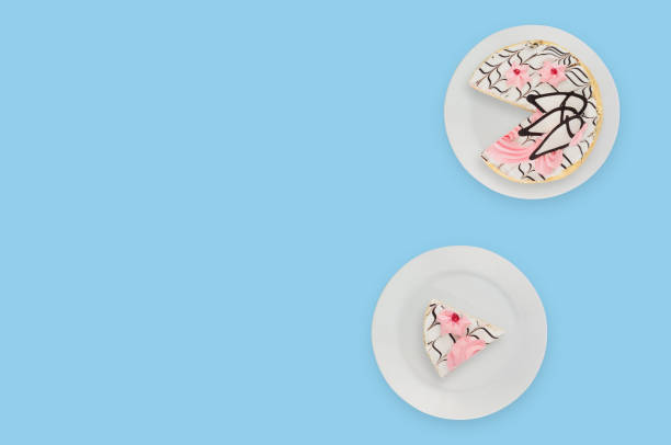 istock One cuted decorated creamy cake in white circle plate on blue table. Top view. Celebration concept. Copy space for your text 1136532194