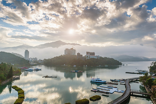 Moody Sunrise over Sun Moon Lake with mist low clouds over the sun moon lake. Sun Moon Lake, Taiwan, Asia.