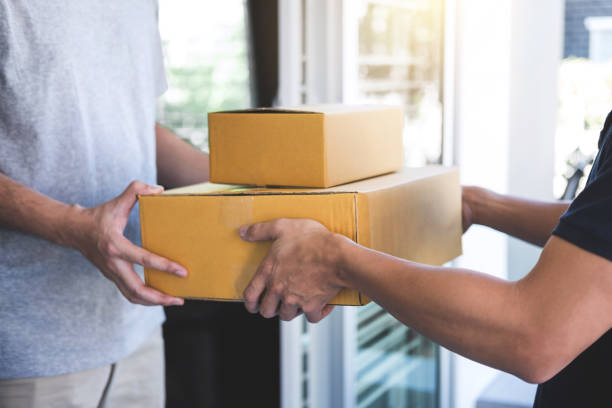istock Delivery Person Giving Packages To Customer 1136532798