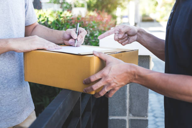 istock Midsection Of Delivery Man Pointing At Signing Sheet 1136532803