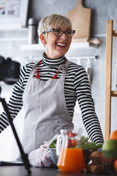 istock Smiling woman in front of home camera, vlogging 1136535439