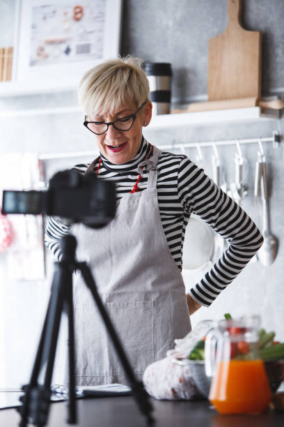 istock Woman adjusting apron, preparing for food vlogging 1136535445