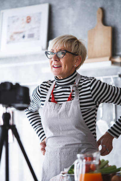 istock Woman adjusting apron, preparing for food vlogging 1136535447