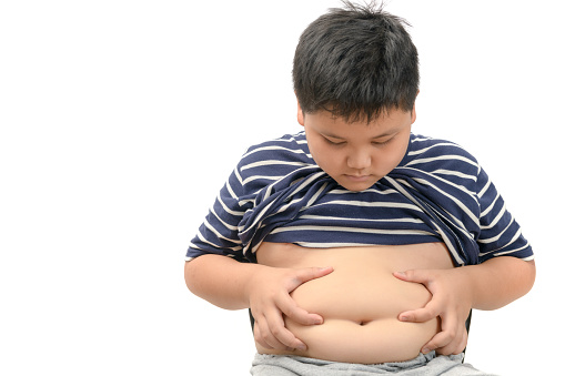 Obesidad niño gordo con sobrepeso aislado en blanco photo