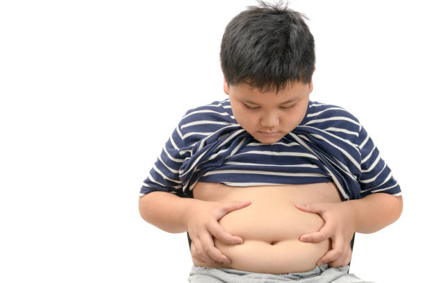 obesidad niño gordo con sobrepeso aislado en blanco - belly button fotografías e imágenes de stock