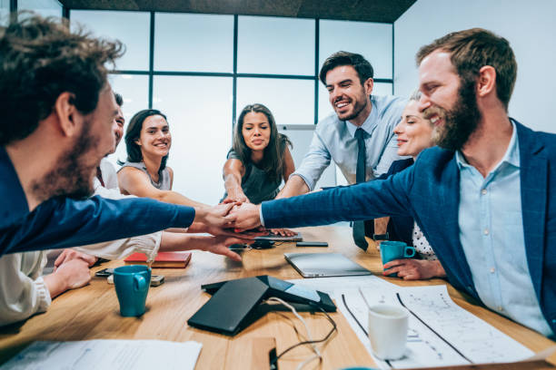 istock Business people stacking hands in conference room 1136538367