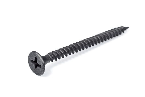 Single dark screw isolated on the white background. Concept of building and repair.