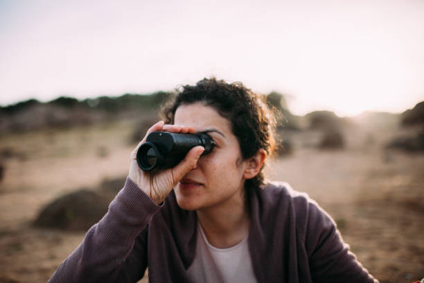istock Woman Looking Through Binocular On Field 1136544092