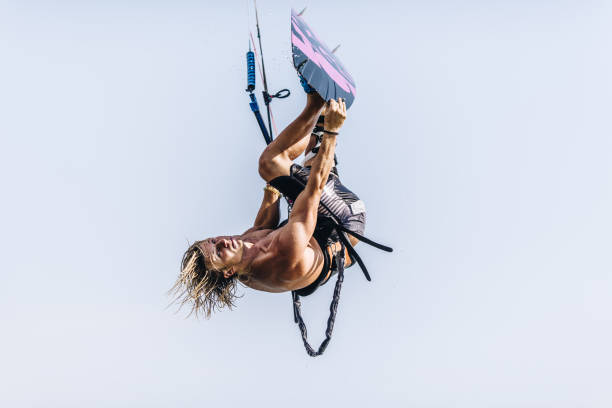 Young man flying with kiteboard against the sky. Copy space.