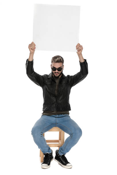 istock man holding blank billboard raised up in the air 1136546467