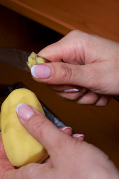 istock Peeling potatoes. Minced meat steaks with potatoes, eggs and cheese. Cooking steps and ingredients. 1136546938