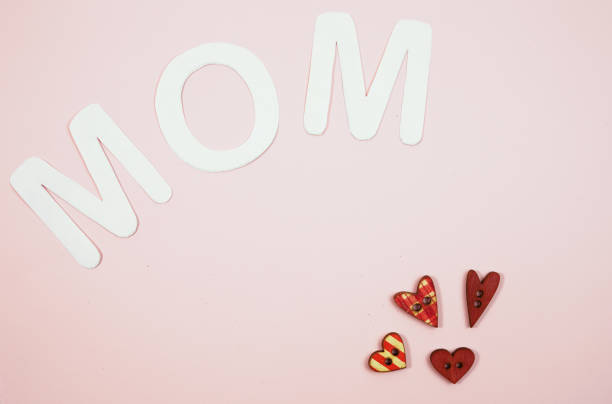 istock MOM Text with hearts on coloful backround 1136547914