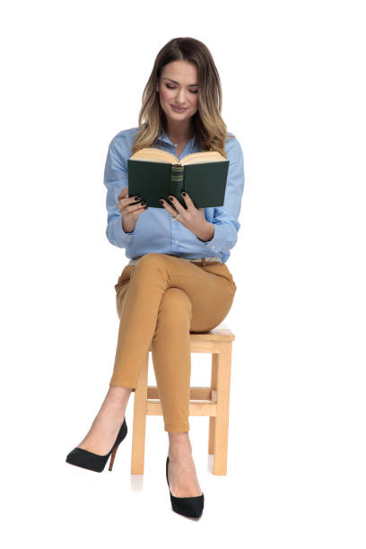 istock captivated smart casual woman reading while sitting 1136548498
