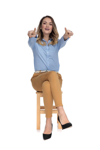 istock attractive businesswoman sits and points at the camera man 1136548693