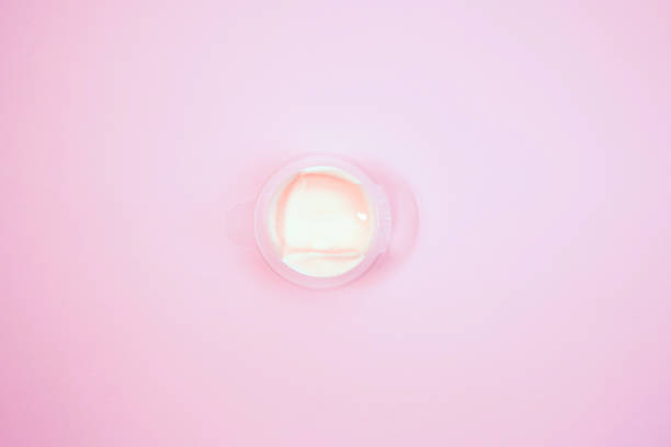 istock Cosmetic cream container on pink background from top view 1136548768