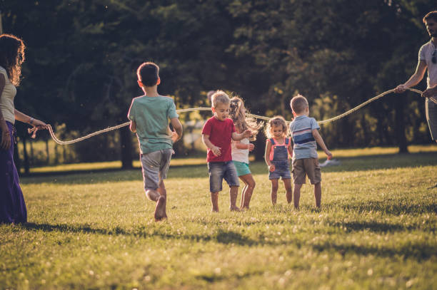 istock Group of children playing in public park 1136550768