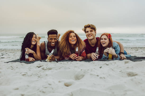 istock Friends having beers at the sea shore 1136551368