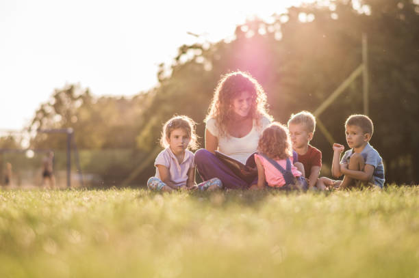 istock Group of happy children having fun in nature 1136551610