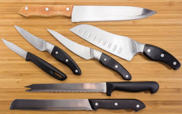 istock Background of different kitchen knives on the bamboo cutting board 1136552450