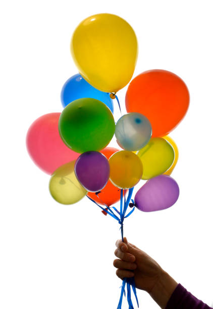 istock Woman hand holding balloons on white background 1136555589