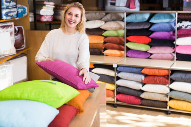 istock Young female customer is choosing new pillow 1136556895