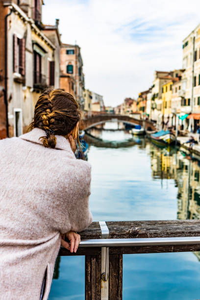 istock Woman from behind looking at a canal in Venice 1136557496