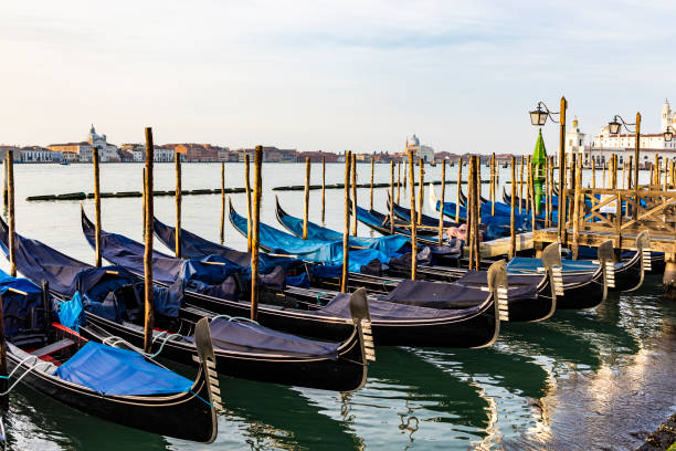 istock Empty gondolas floating on a lagoon of Venice, Italy 1136557541