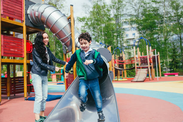 istock Son and mother in the amusement park. 1136558983