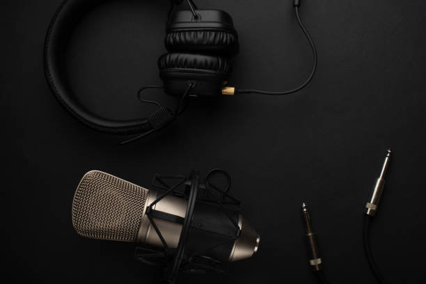 istock Microphone with headphones. Studio recording, broadcasting, blog, speaker. On a black background 1136558994