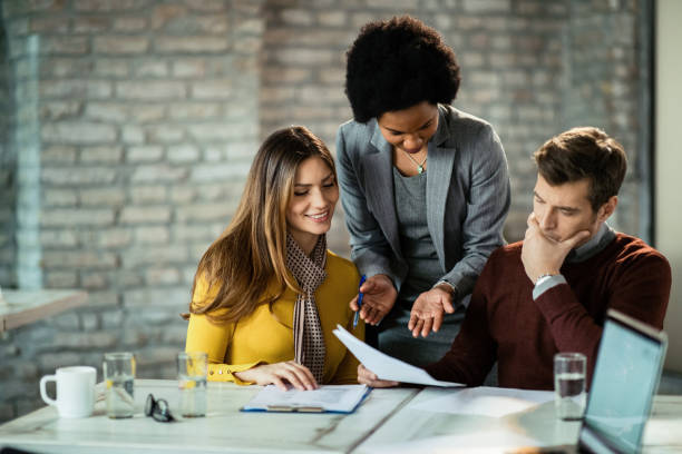 istock African American financial consultant analyzing documents with a couple during the meeting. 1136560033