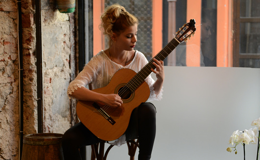 Woman playing guitar and enjoying