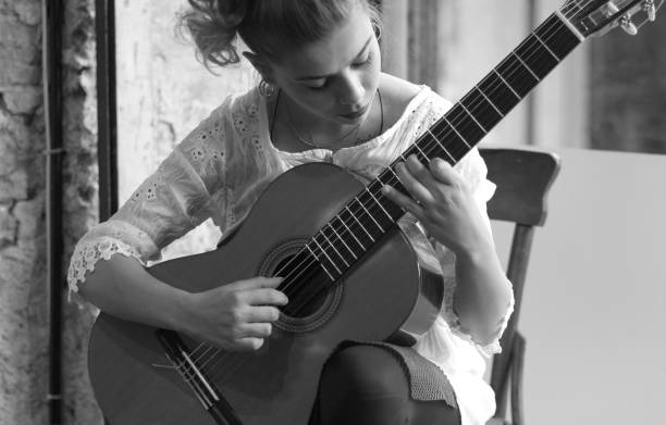 Woman playing guitar and enjoying