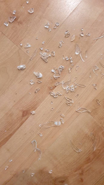 istock Broken glass on wooden floor 1136563620