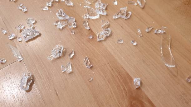 istock Broken glass on wooden floor 1136563629