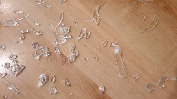 istock Broken glass on wooden floor 1136563644