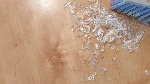 istock Brush sweeping up broken glass on wooden floor 1136563646
