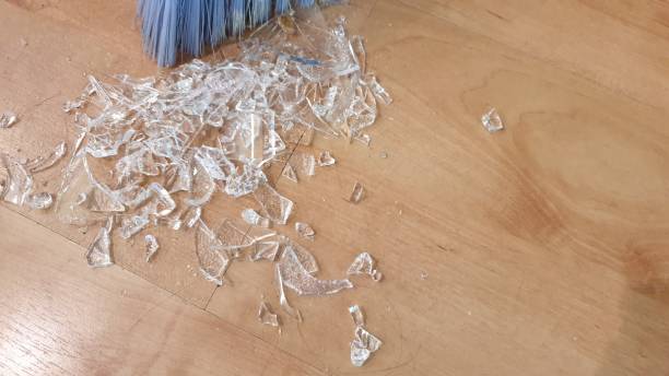 istock Brush sweeping up broken glass on wooden floor 1136563647