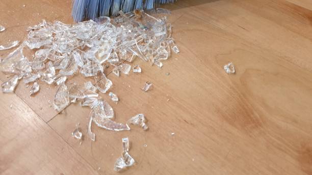 istock Brush sweeping up broken glass on wooden floor 1136563656