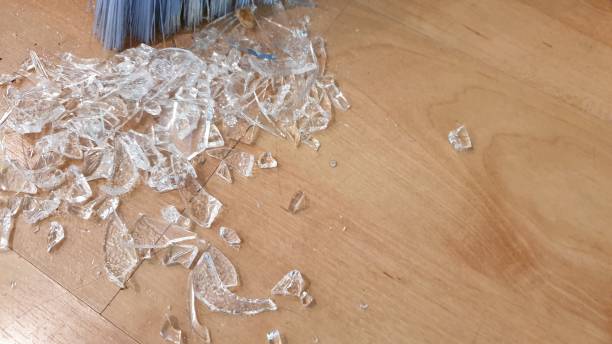 istock Brush sweeping up broken glass on wooden floor 1136563665